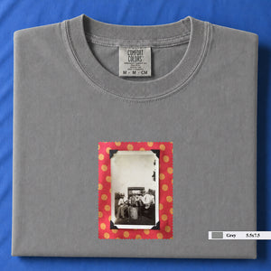 Light grey colored folded t-shirt with small vintage photo of musicians playing