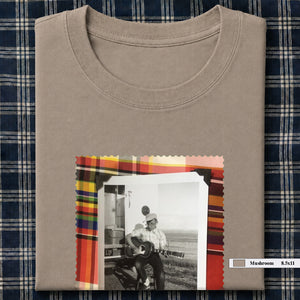 mushroom colored folded tee shirt with large vintage photo of guitar player on front