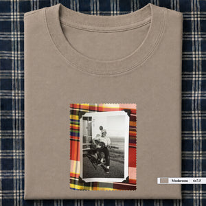 mushroom colored folded tee shirt with small vintage photo of guitar player on front
