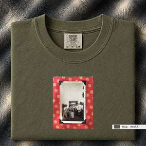 Olive colored folded t-shirt with small vintage photo of musicians playing