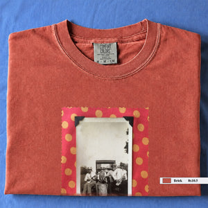 Orange colored folded t-shirt with large vintage photo of musicians playing