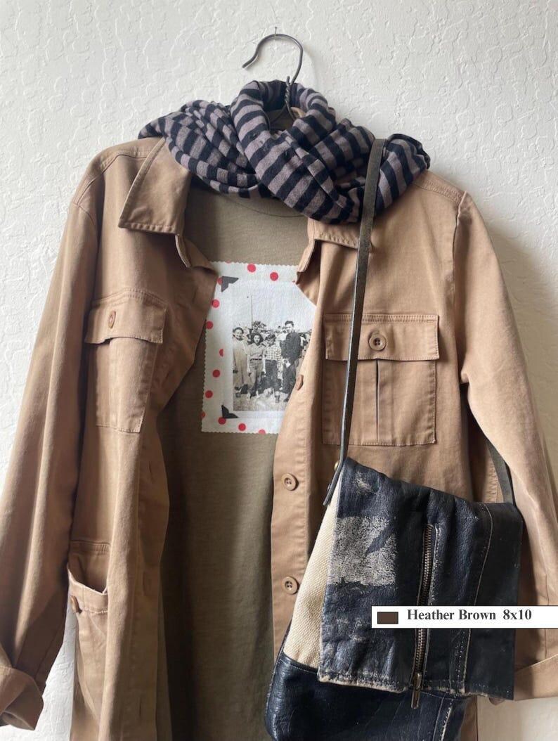 This outdoor jacket is shown with a khaki t-shirt with a vintage family photo on the front of shirt