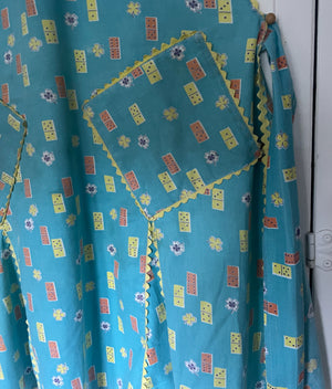Pocket detail of ricrac on domino print fabric on vintage apron