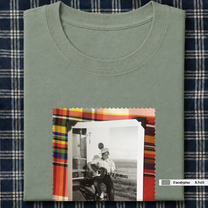 sage green folded tee shirt with large vintage photo of guitar player on front