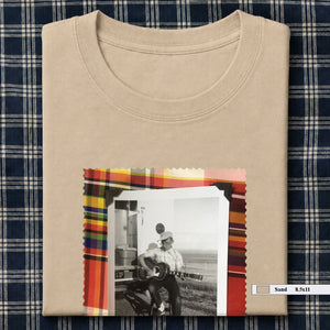 sand colored folded tee shirt with large vintage photo of guitar player on front