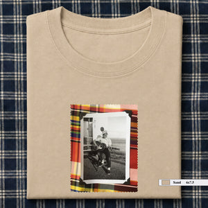 sand colored folded tee shirt with small vintage photo of guitar player on front