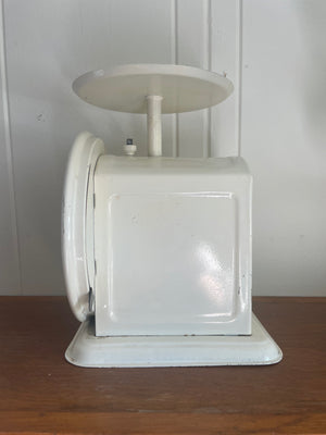 Side view of a vintage Chatillion dietary scale with white finish and decorative design.