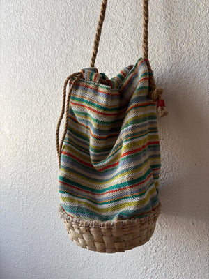 Back view of a colorful basket bag with soft rope strap