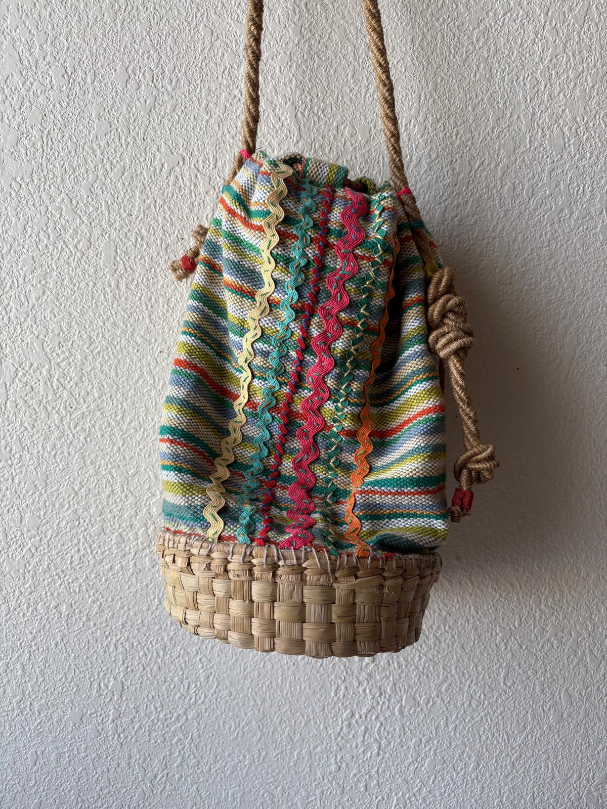 Full length of a colorful basket bag with soft rope strap