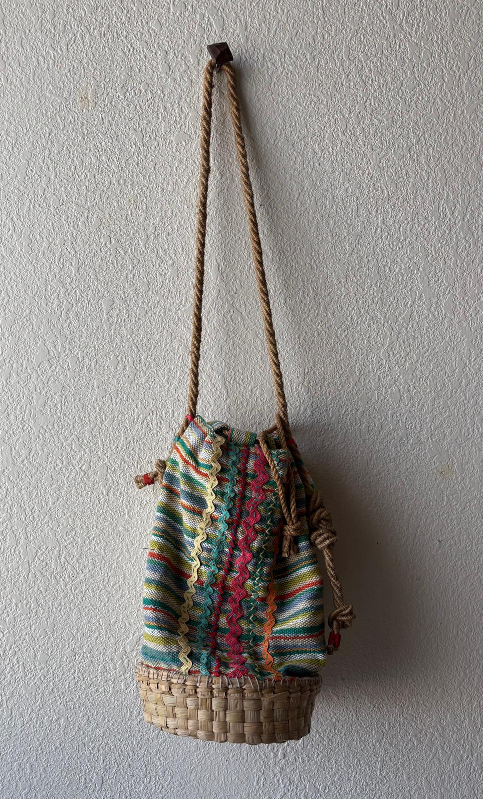 Full length of a colorful basket bag with soft rope strap