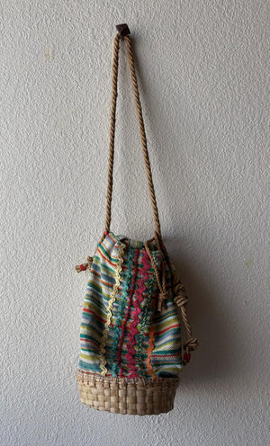 Full length of a colorful basket bag with soft rope strap