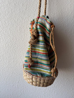 Side view of a colorful  basket bag with soft rope strap