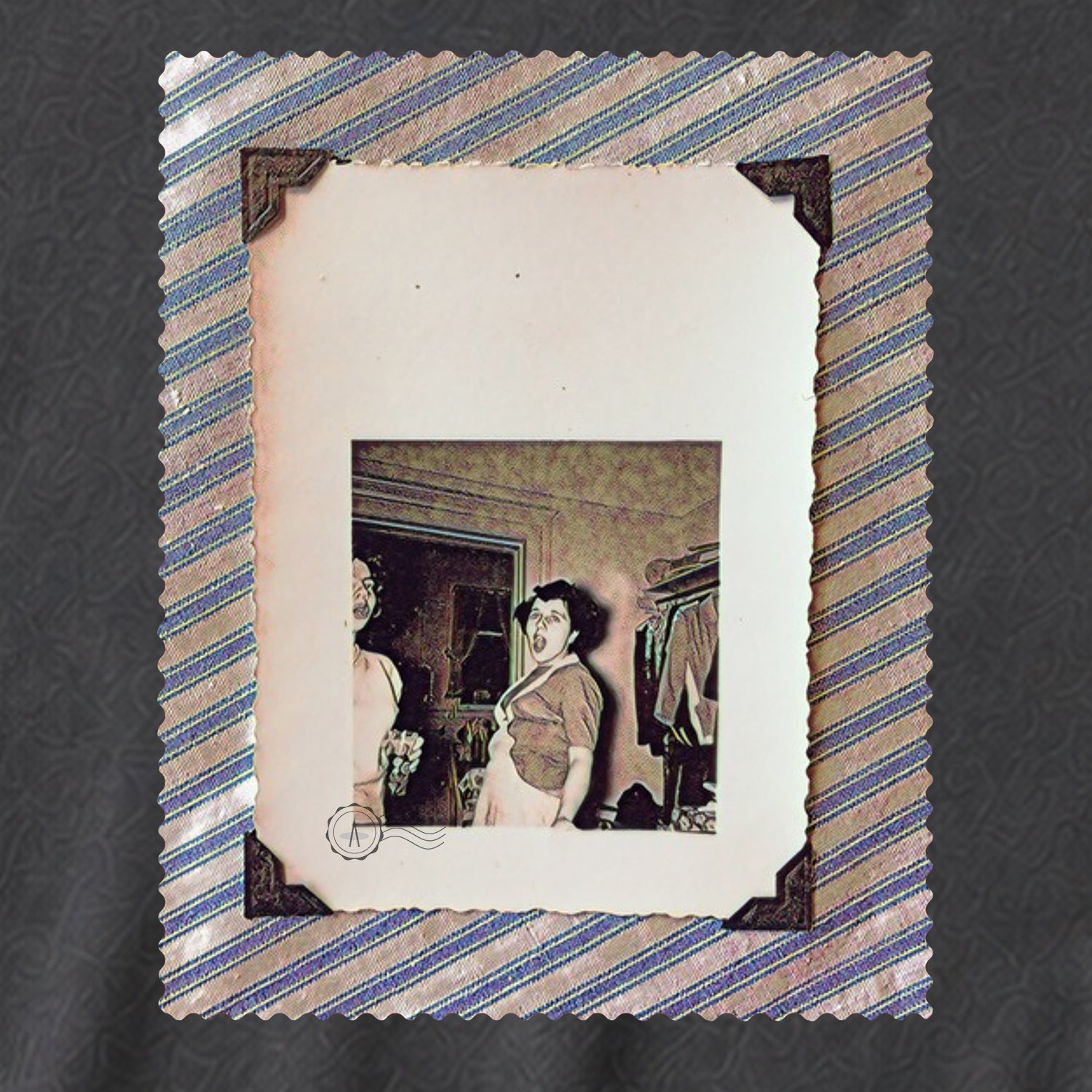 grey t-shirt laying flat with large vintage photo of screaming lady on front