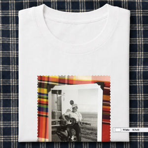white folded tee shirt with vintage photo of guitar player on front