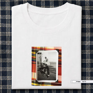white folded tee shirt with small vintage photo of guitar player on front