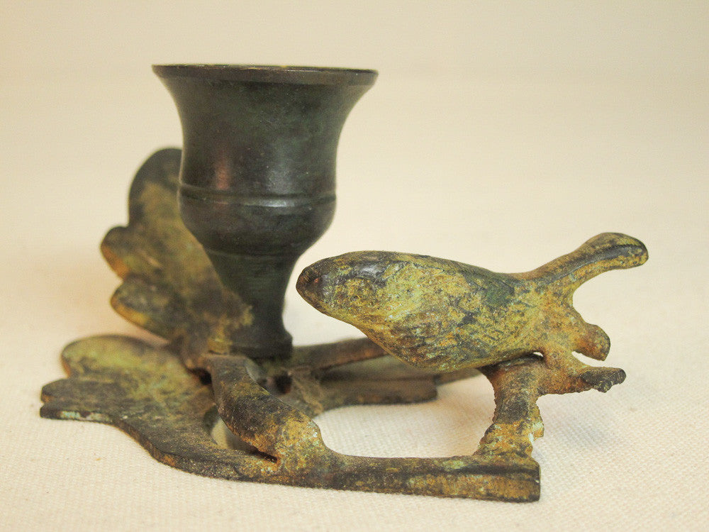 Iron branch candle holder with resting bird in green patina.
