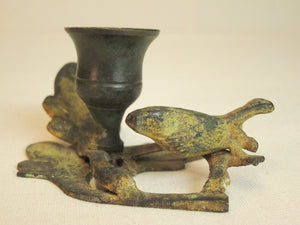 Iron branch candle holder with resting bird in green patina.
