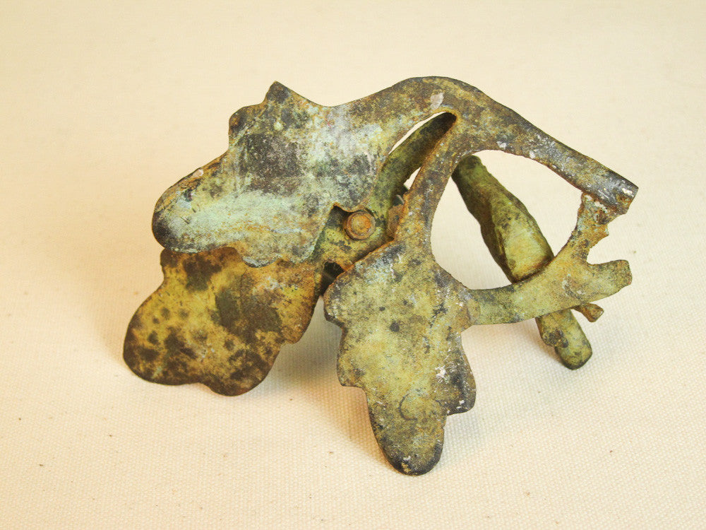 Iron branch candle holder with resting bird in green patina.