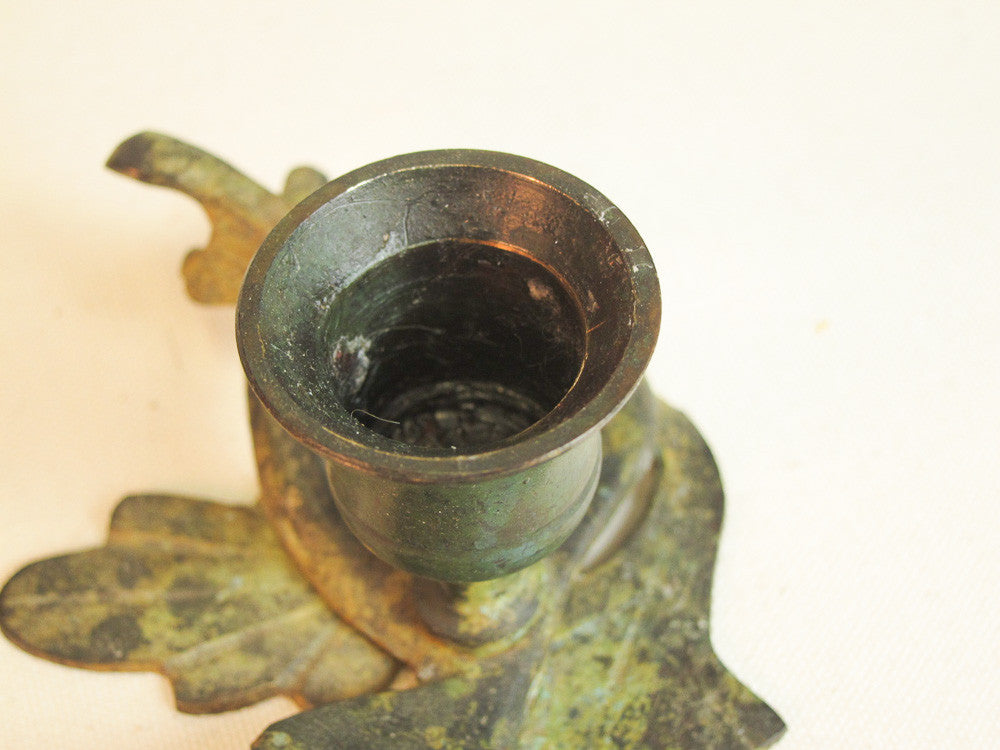 Iron branch candle holder with resting bird in green patina.
