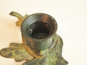 Iron branch candle holder with resting bird in green patina.