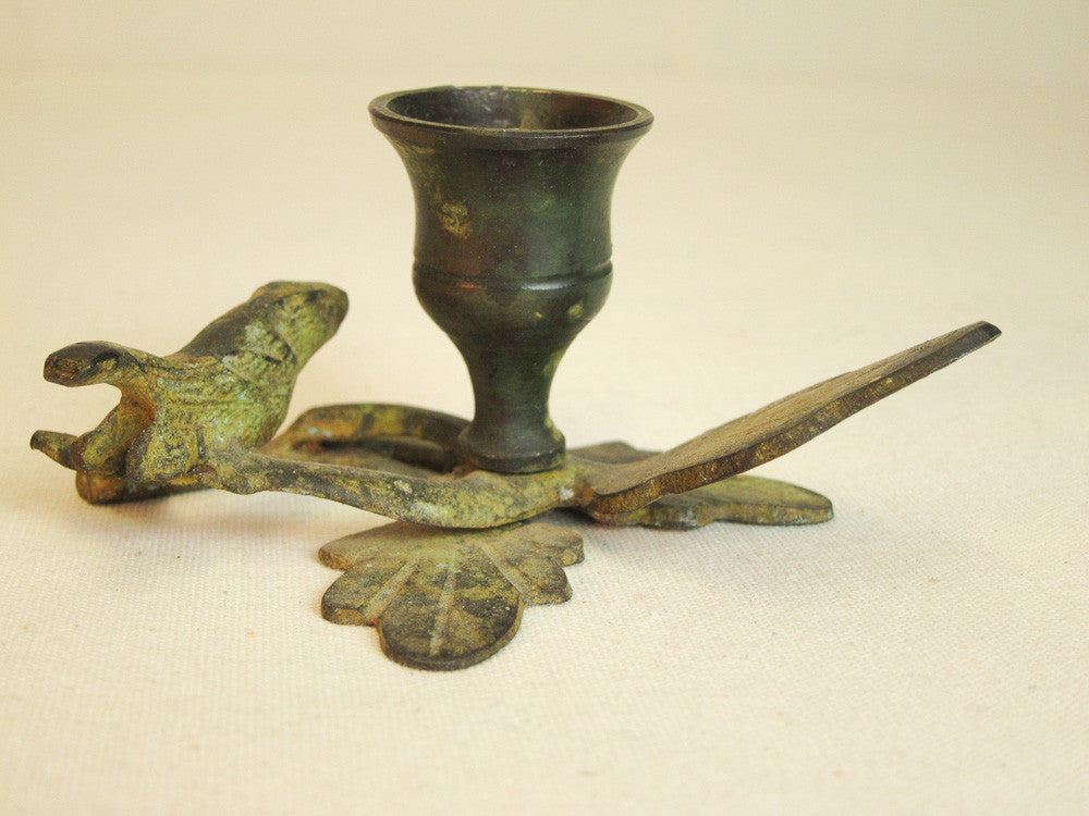 Iron branch candle holder with resting bird in green patina.