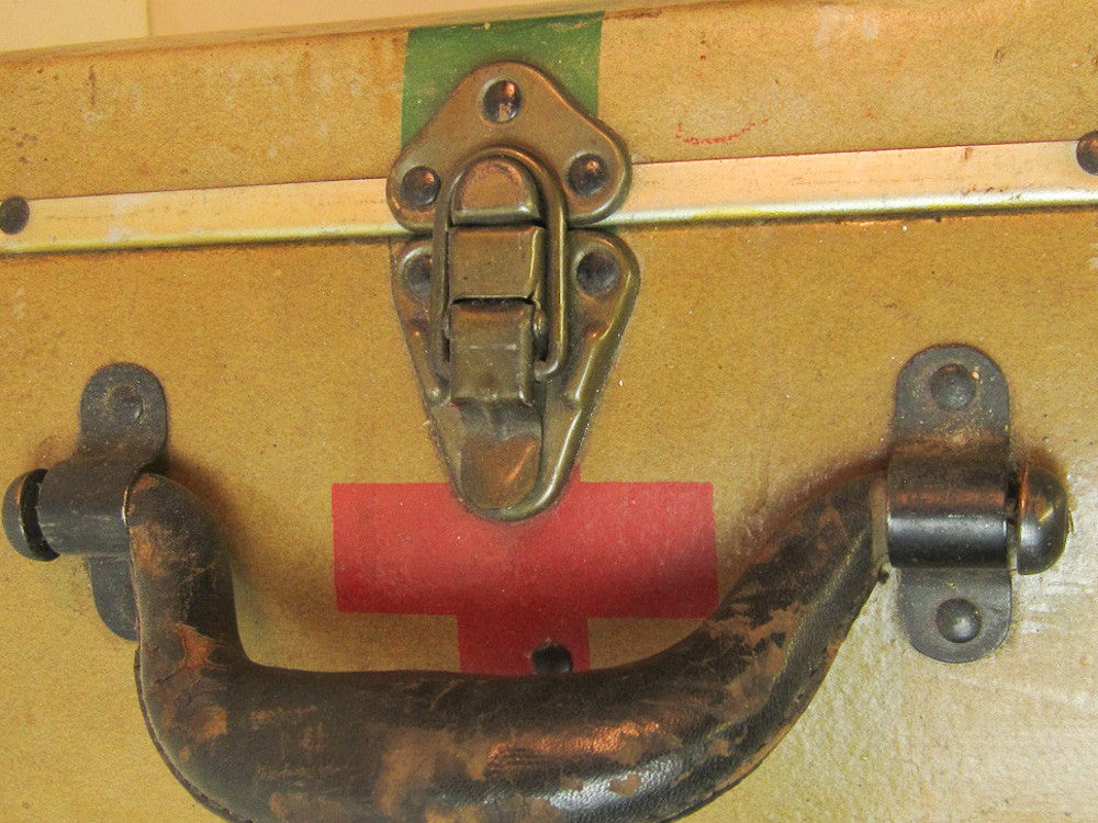 Vintage Red Cross suitcase with military collectible design.