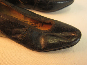 Vintage black leather doll shoes.
