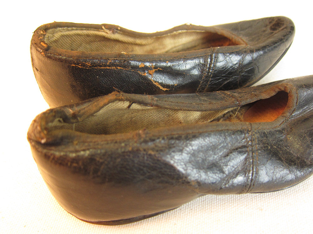 Vintage black leather doll shoes.
