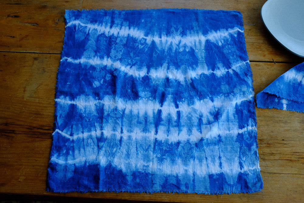 Handmade indigo tie-dyed linen napkins with unique designs.
