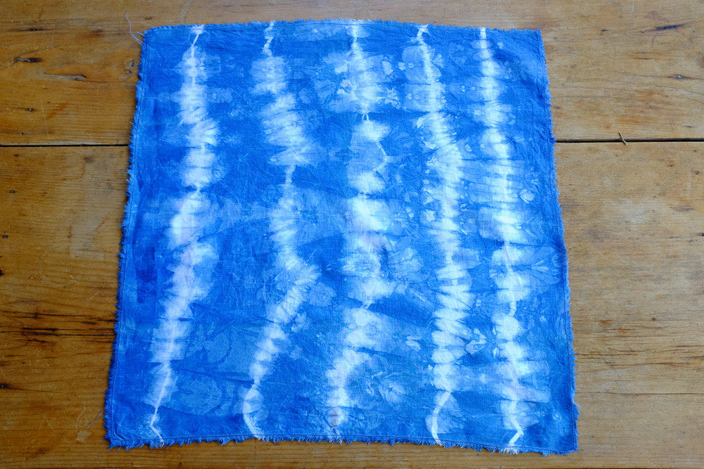 Handmade indigo tie-dyed linen napkins with unique designs.