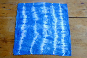 Handmade indigo tie-dyed linen napkins with unique designs.