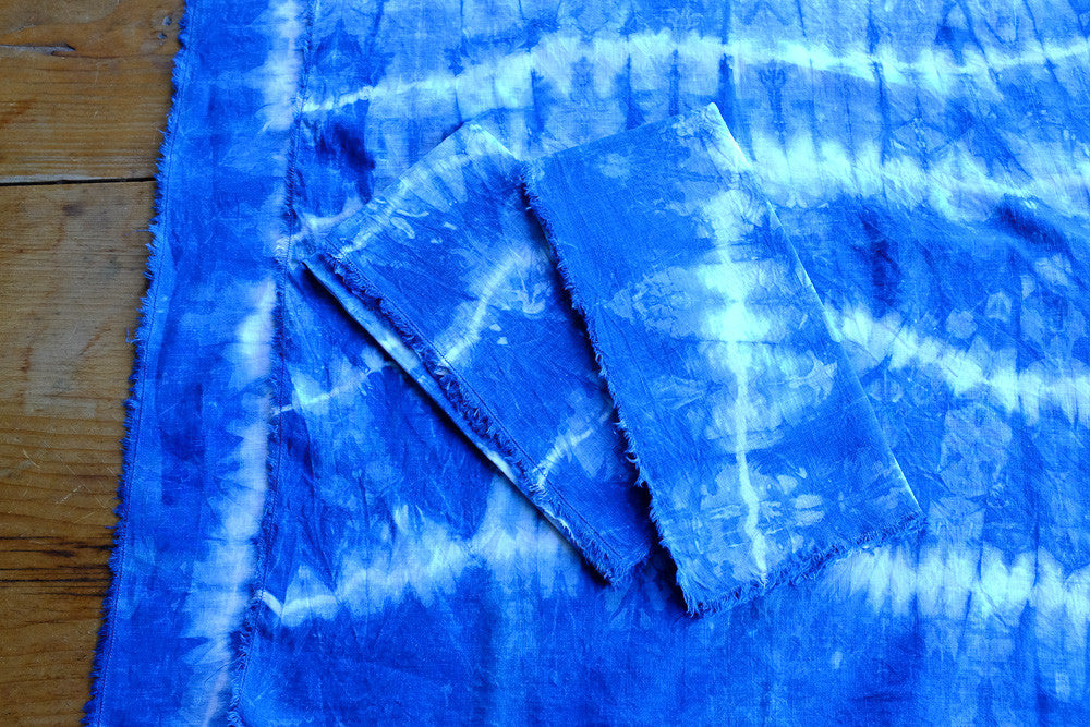 Handmade indigo tie-dyed linen napkins with unique designs.