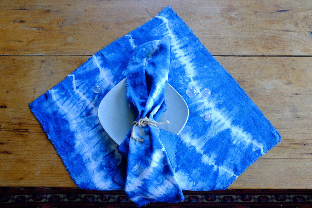 Handmade indigo tie-dyed linen napkins with unique designs.