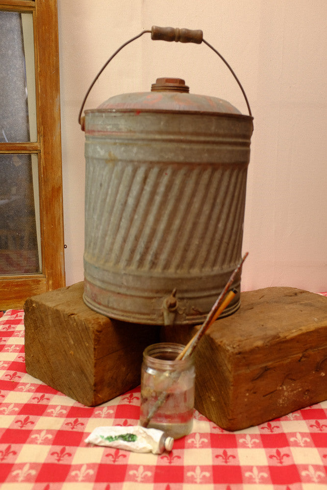 Vintage liquid dispenser with antique farm equipment design