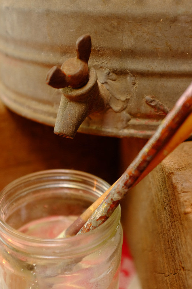 Vintage liquid dispenser with antique farm equipment design