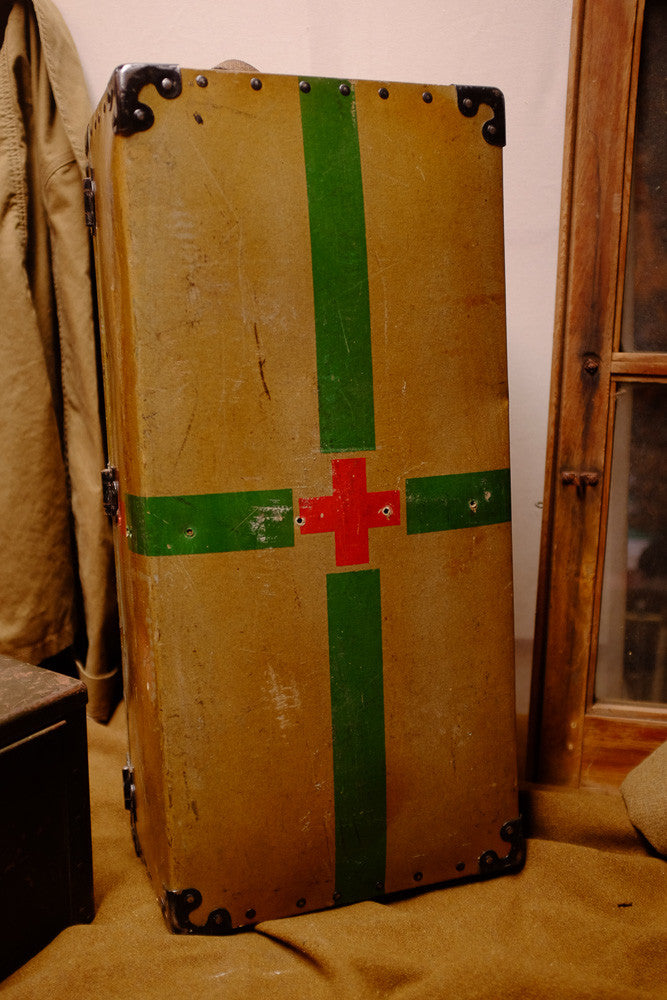 Vintage Red Cross suitcase with military collectible design.
