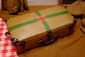 Vintage Red Cross suitcase with military collectible design.