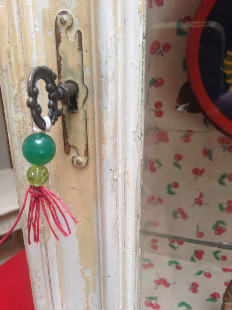 Vintage one-door cherry display cabinet with original glass and exterior paint.