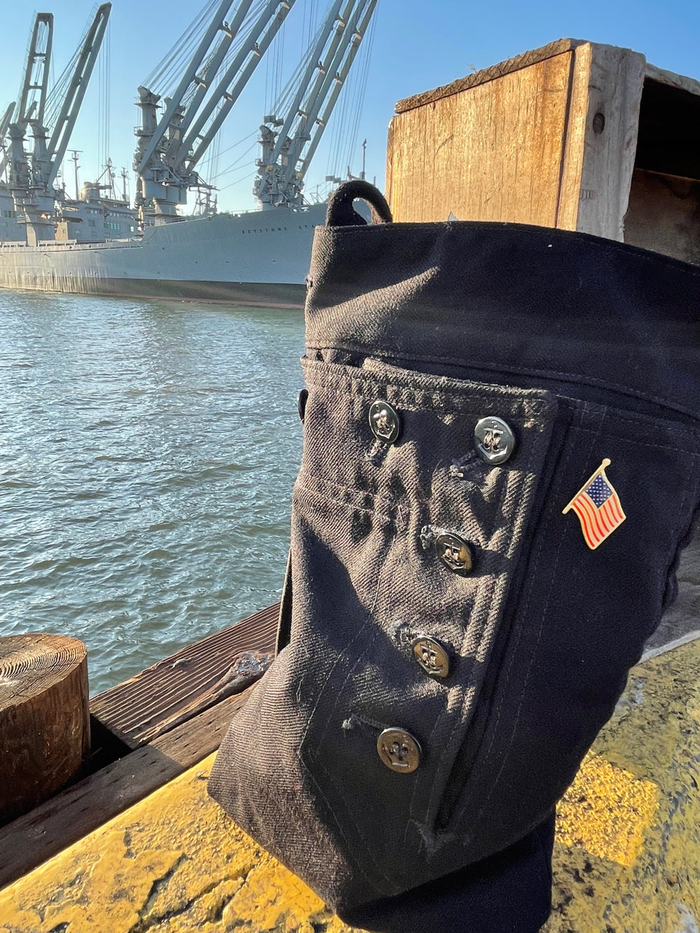Front shot of the handmade navy shoulder bag for carrying bottles and accessories.