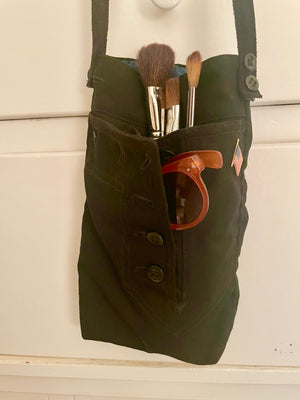 Front shot of handmade navy shoulder bag for carrying bottles and accessories.