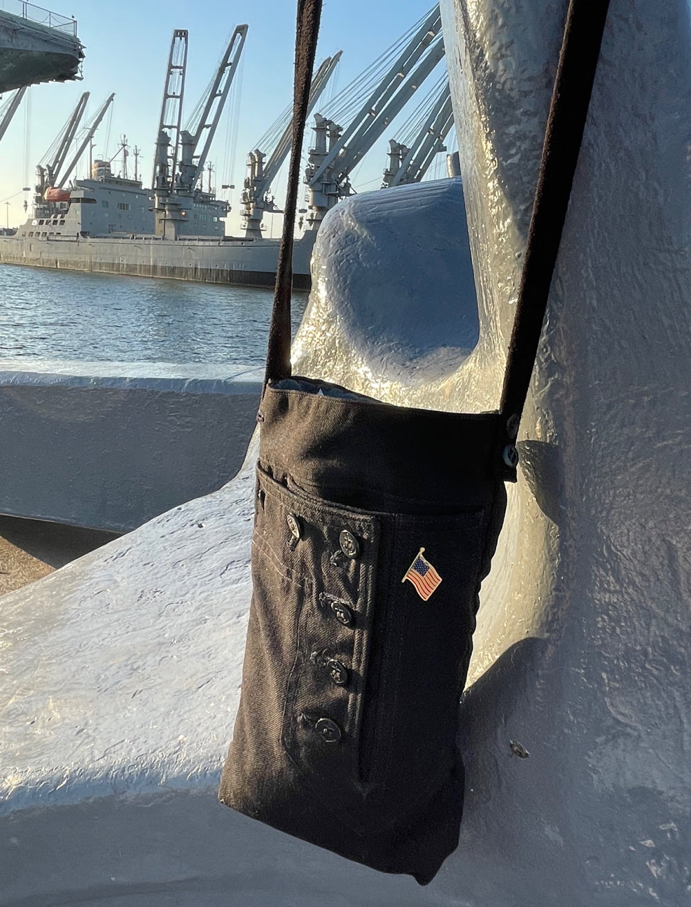 Front shot of the handmade navy shoulder bag for carrying bottles and accessories.