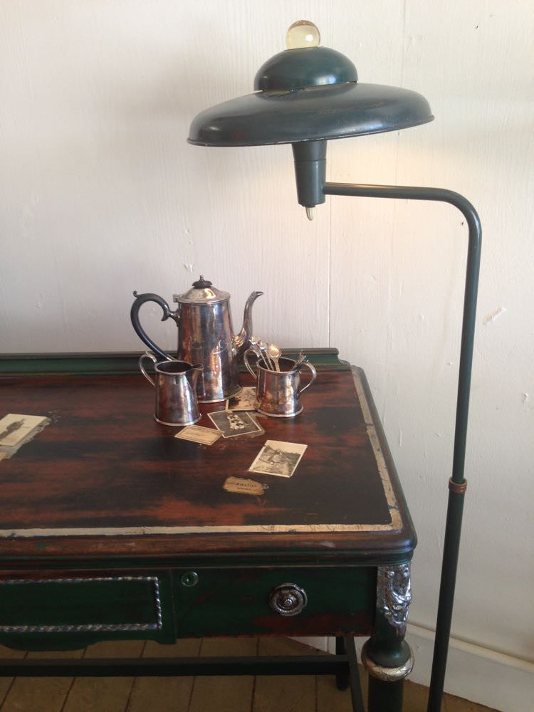 Colette's collaged desk with vintage photos and silver leaf accents.