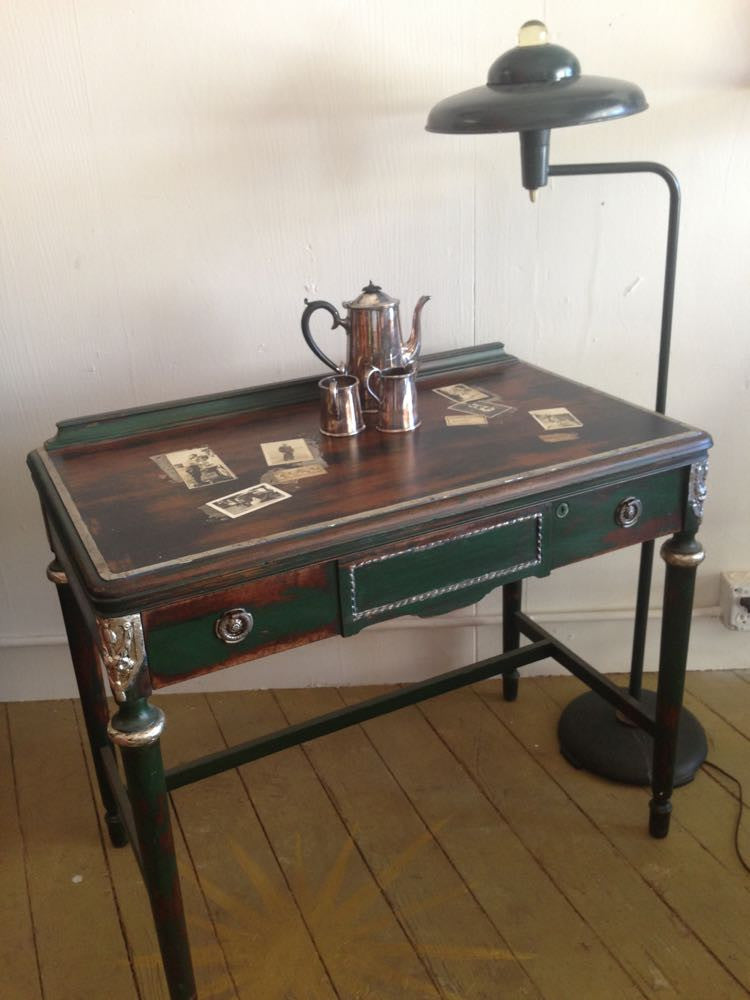 Colette's collaged desk with vintage photos and silver leaf accents.