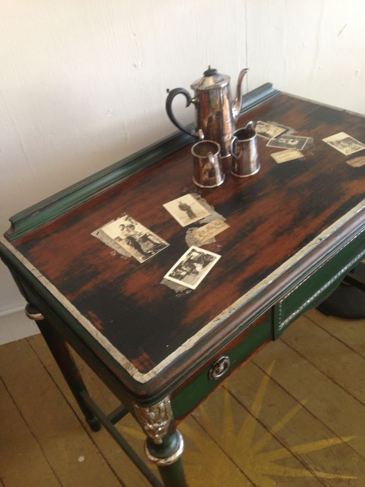 Colette's collaged desk with vintage photos and silver leaf accents.