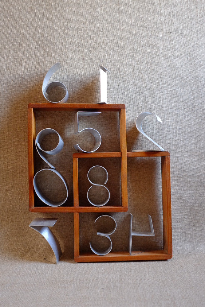 Bent aluminum numbers for decorative wall art and unique displays.