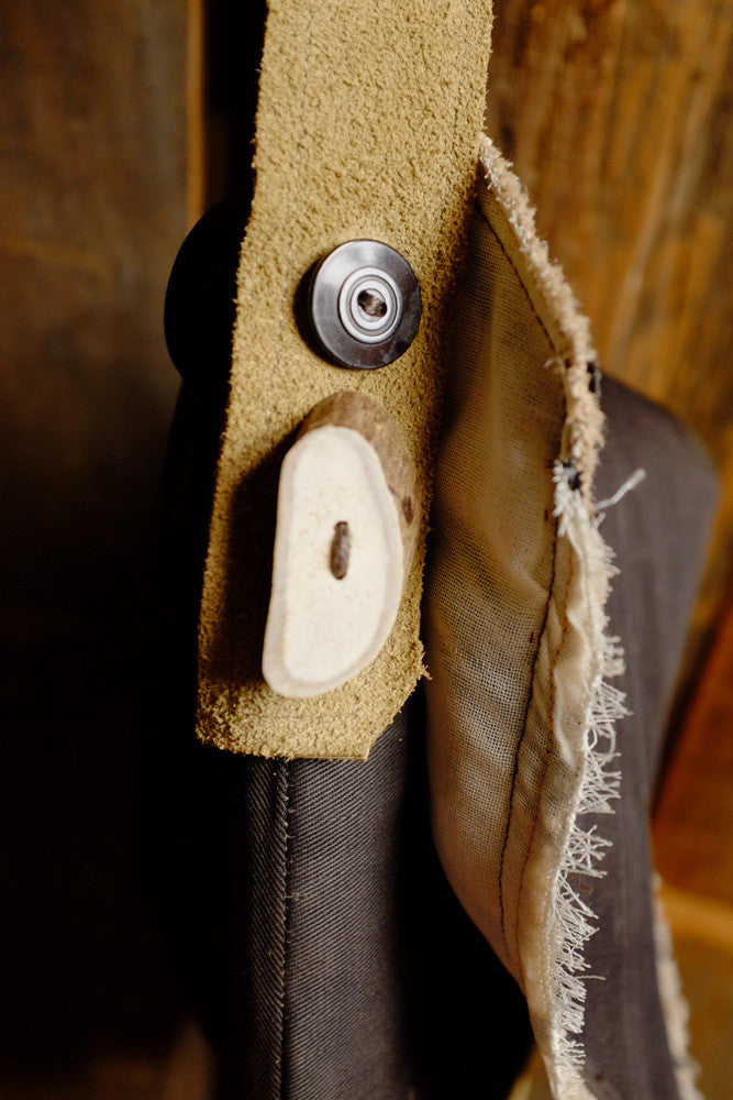 Canvas and suede shoulder bag for tablet storage and outdoor use.