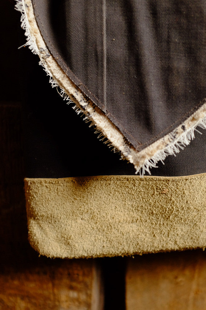 Canvas and suede shoulder bag for tablet storage and outdoor use.
