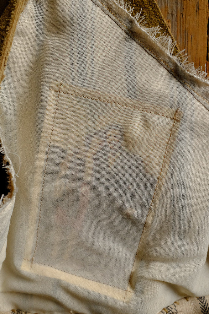 Canvas and suede shoulder bag for tablet storage and outdoor use.