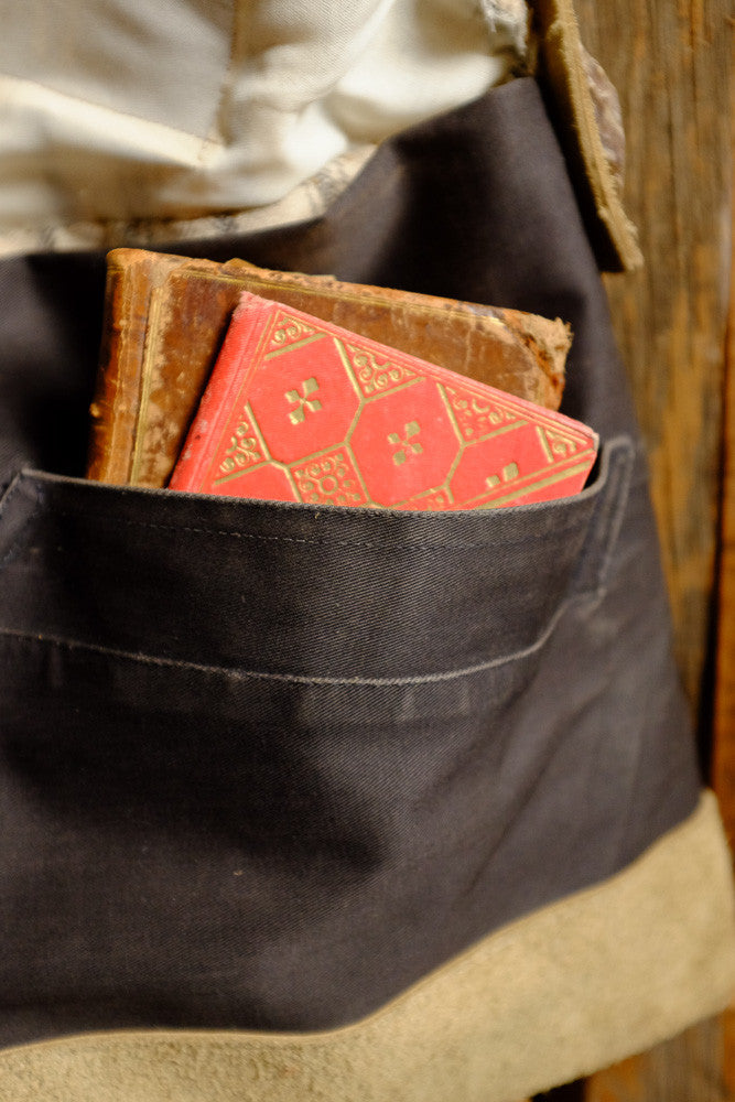 Canvas and suede shoulder bag for tablet storage and outdoor use.