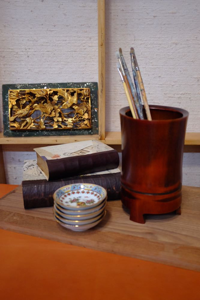 Bamboo vase and handmade drawing accessories for artistic enthusiasts.